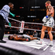 YouTube personality Jake Paul (R) knocks out former UFC welterweight champion Tyron Woodley in an eight-round cruiserweight bout at the Amalie Arena in Tampa, Florida, on December 18, 2021. (Photo by CHANDAN KHANNA / AFP)